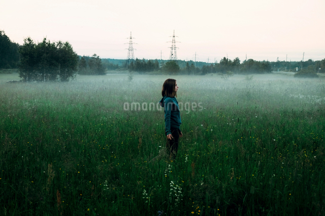 Side view of woman standing on grassy field against clear sky during ...