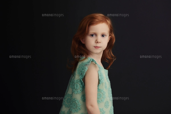Portrait of smiling girl holding putter while standing at golf courseの ...