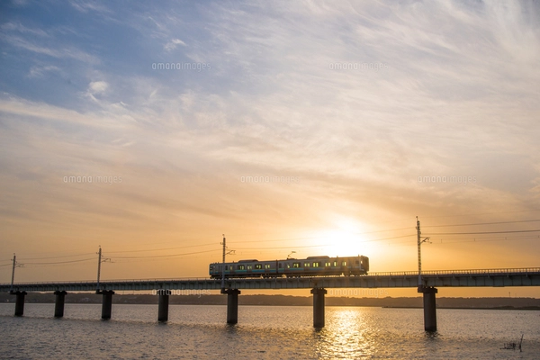 霞ヶ浦北浦夕焼け空の下北浦橋梁を走るJR鹿島線の写真素材